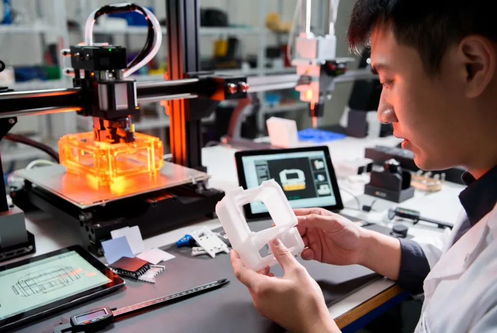 Engineer inspecting 3D printed prototype